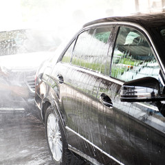 Car wash with flowing water and foam..