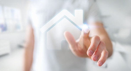 Businessman touching 3D rendering icon house with his finger