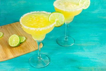 Lemon Margarita cocktails with limes and copyspace