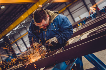 Worker Using Angle Grinder