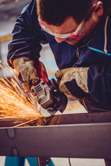 Worker Using Angle Grinder