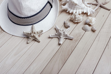 Straw hat and sunglasses on wooden boards.