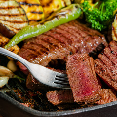 slicing delicious roasted meat on fork with vegetable, healthy lifestyle