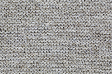 Фактура вязаного коричневого полотна. Чередование рядов - изнаночная и лицевая петля