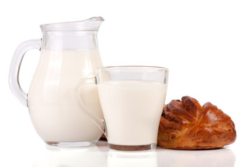 jug and glass of milk with a loaf of bread isolated on white background