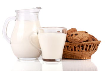 jug and glass of milk with oatmeal cookies in a wicker basket isolated on white background