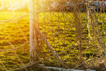 Fototapeta na wymiar Soccer goalpost and net on practicing pitch