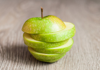 Green apple on a wooden background. The concept of a healthy diet.