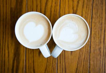 two cups of coffee cappuccino with heart shape