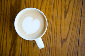 A cup of coffee cappuccino with heart shape.