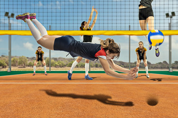 Female volleyball player reaching the ball in jump