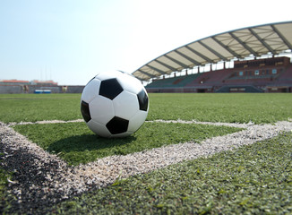 soccer ball on stadium grass line.