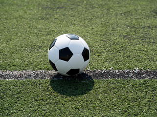 soccer ball on stadium grass line.