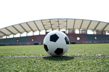 Fototapeta na wymiar soccer ball on stadium grass line.