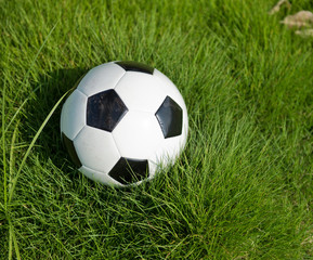Soccer football on the green grass.
