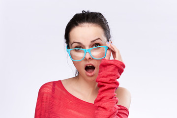 surprised woman in a red sweater and blue glasses