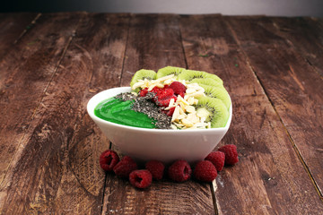 breakfast smoothie bowl with raspberries, kiwi and chia - diet concept