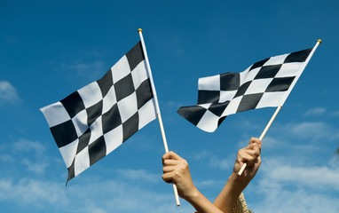 checkered race flag in hand.