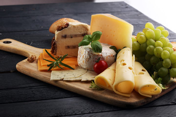 Cheese platter with different cheese and grapes