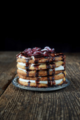Round cake on a plate with chocolate-covered berries