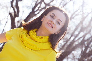 Fashion smiling lady girl in yellow dress in the park in summer