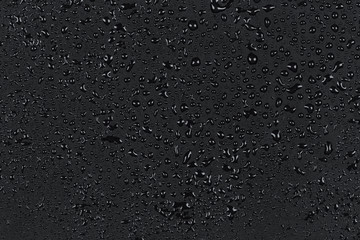 Water drops on dark stone
