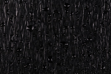 Water drops on dark stone