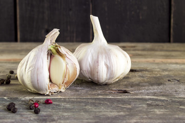 Sprouted garlic with papper on a rustic wooden table . Springtime
