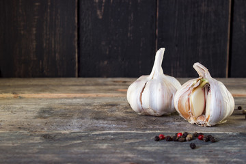 Sprouted garlic with pepper on a wooden planks . spring morning .