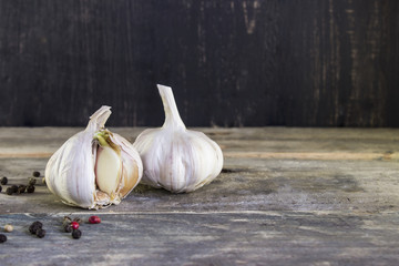 Sprouted garlic with pepper on a wooden table