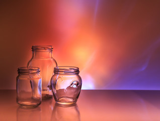 Three glass jars on a colored background