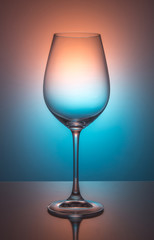 Wine glass on color background