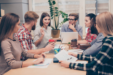 Young colleagues sitting at the business meeting in the office