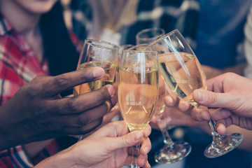 Close up of happy best friends clinking with glasses of wine