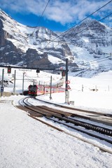 Fototapeta premium Kleine Scheidegg train station under Jungfrau, Monch and Eiger peaks in Swiss Alps, Wengen, Switzerland