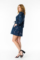 Young elegant female in light summer dress, over white background