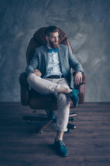stylish serious minded brutal young man with red mustache, beard and beautiful hairstyle ponder...