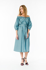 Young elegant female in light summer dress, over white background