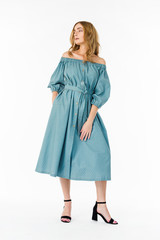 Young elegant female in light summer dress, over white background