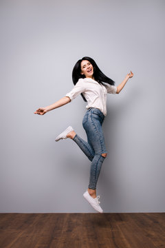 Full portrait of happy laughing jumping woman who is excited because of passing all exams at university