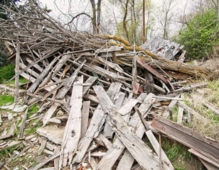 Fallen tree on destroyed wood building