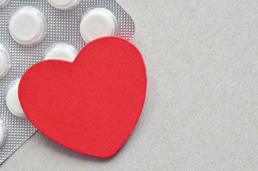 red heart with packing of tablets