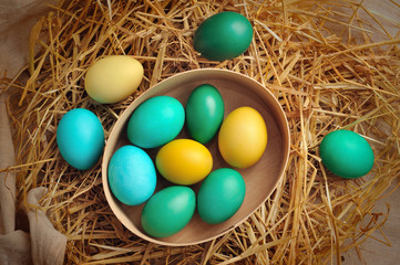 Wooden basket full of colorful Easter eggs