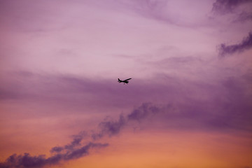 airplane flying at sunset