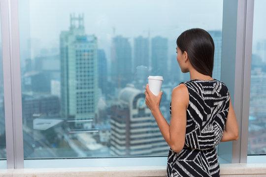 Business Woman Drinking Coffee In Office