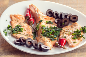 fillet of salmon with olives, herbs and spicy red pepper