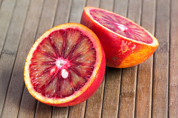  Blood orange on a wooden striped background