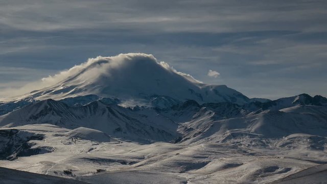 Russia, timelapse. The formation and movement of clouds above the volcano Elbrus in the Caucasus Mountains in winter.