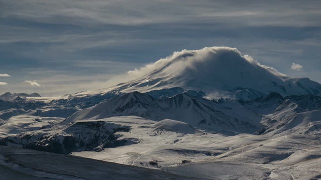 Russia, timelapse. The formation and movement of clouds above the volcano Elbrus in the Caucasus Mountains in winter.