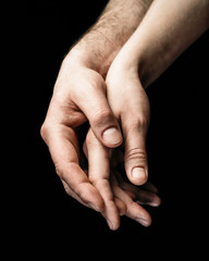 A gentle touch of two hands. Concept of LGBT love, caring, tolerance, etc.